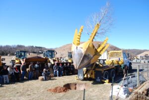 RELS Landscaping employees planting a tree using a large machine