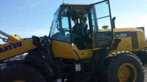 RELS employee driving a frontend loader