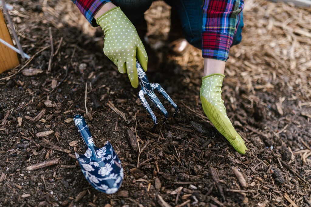 person wearing plaid composting garden