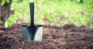 shovel buried in brown mulch
