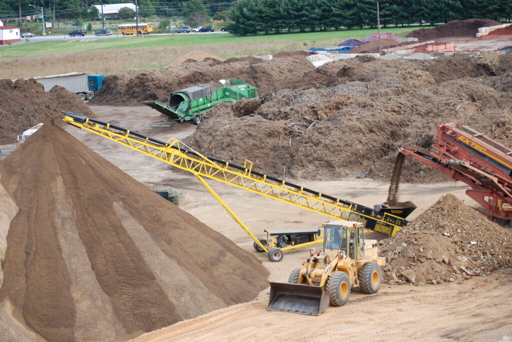 construction equipment creating a large pile of fill dirt